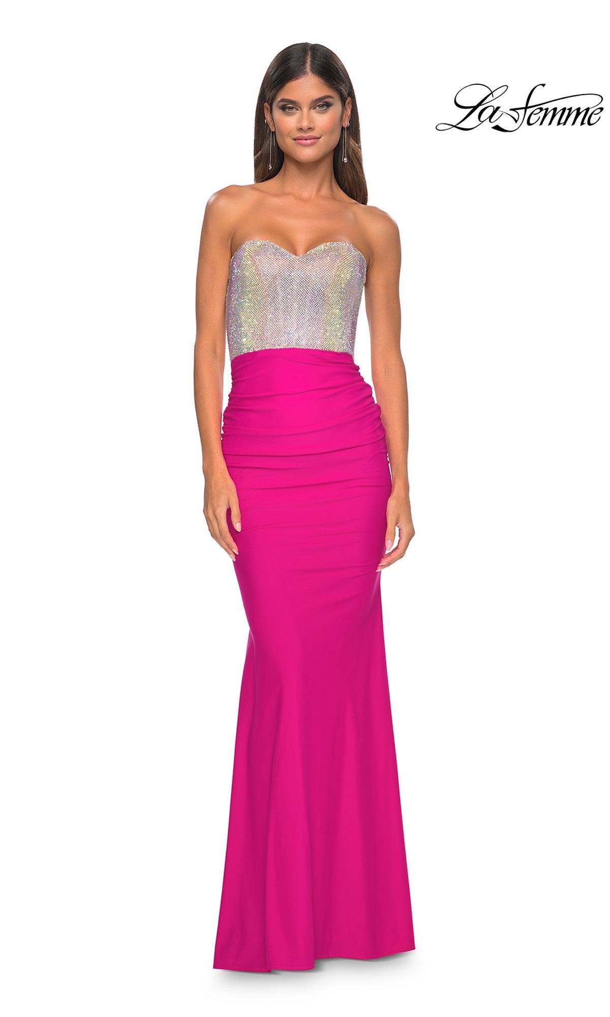 A woman models the La Femme 32440 strapless hot pink long prom dress with a silver sequin bodice, standing against a white background.